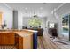 Open concept living space with wood floors, bar, and large windows providing natural light at 1523 Red Plum Holw, Deland, FL 32720