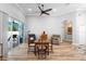 Relaxing living area features wood floors, a ceiling fan, neutral walls, and glass sliding doors at 1523 Red Plum Holw, Deland, FL 32720