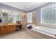 Well-lit main bathroom with walk-in shower, soaking tub, and large vanity at 1523 Red Plum Holw, Deland, FL 32720