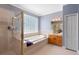 Bright main bathroom with shower, soaking tub, and vanity with cabinets at 1523 Red Plum Holw, Deland, FL 32720