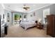 Bright main bedroom with neutral tones, carpet, and sliding glass doors to the outside at 1523 Red Plum Holw, Deland, FL 32720