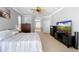 Comfortable main bedroom with carpet, TV, and access to main bathroom at 1523 Red Plum Holw, Deland, FL 32720
