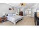 Spacious main bedroom with carpet, TV, and view into main bathroom with soaking tub at 1523 Red Plum Holw, Deland, FL 32720