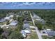 Expansive aerial view of a residential neighborhood with tree-lined streets and single-Gathering homes on verdant lots at 156 N Cory Dr, Edgewater, FL 32141