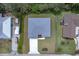 Aerial view of modern single-story home with a well-manicured lawn, new roof, and a long driveway at 156 N Cory Dr, Edgewater, FL 32141