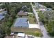 A bird's-eye view of a tidy gray roofed home nestled amongst lush trees in a peaceful neighborhood at 156 N Cory Dr, Edgewater, FL 32141