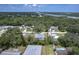 A picturesque aerial view shows a cozy neighborhood near a waterway and vast wooded areas at 156 N Cory Dr, Edgewater, FL 32141