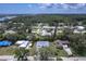An expansive aerial shot of a neighborhood near a tranquil river and lush trees at 156 N Cory Dr, Edgewater, FL 32141