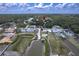 Aerial view of a quiet, secluded neighborhood with waterfront access and lush greenery under a partly cloudy sky at 156 N Cory Dr, Edgewater, FL 32141