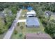 A well-maintained new home with a manicured lawn and mature palm trees, nestled in a quiet residential area at 156 N Cory Dr, Edgewater, FL 32141