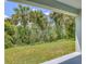 View of the lush backyard from the covered patio area at 156 N Cory Dr, Edgewater, FL 32141