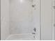 Modern bathroom features a shower with tiled walls, tub and sleek fixtures at 156 N Cory Dr, Edgewater, FL 32141