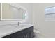 Modern bathroom featuring vanity with quartz countertops, lighting, and stylish fixtures at 156 N Cory Dr, Edgewater, FL 32141