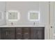 Elegant bathroom with double sinks, quartz countertops, dark wood cabinets, and illuminated mirrors at 156 N Cory Dr, Edgewater, FL 32141