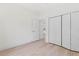 Bedroom featuring light wood flooring, closet, and doorway to the next room at 156 N Cory Dr, Edgewater, FL 32141