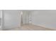 Spacious bedroom featuring wood floors, white walls, and doorway to the bedroom at 156 N Cory Dr, Edgewater, FL 32141