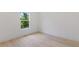 Bright bedroom with light wood flooring and a view of the landscaped yard at 156 N Cory Dr, Edgewater, FL 32141