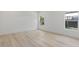 Well-lit bedroom features wood floors, white walls, and two windows for a bright, airy feel at 156 N Cory Dr, Edgewater, FL 32141
