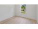 Bright bedroom with light wood flooring and a window view of outside landscape at 156 N Cory Dr, Edgewater, FL 32141