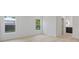 Bedroom with wood floors, white walls, two windows and hallway to bathroom at 156 N Cory Dr, Edgewater, FL 32141