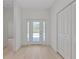 Bright foyer featuring wood-look flooring and a glass front door at 156 N Cory Dr, Edgewater, FL 32141