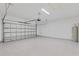 Spacious two-car garage with epoxy flooring, overhead lighting and a water heater at 156 N Cory Dr, Edgewater, FL 32141