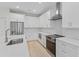 Well-lit kitchen featuring a central island with seating, updated appliances, and ample counter space at 156 N Cory Dr, Edgewater, FL 32141