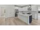 Modern kitchen features stainless appliances, white cabinets, and a central island at 156 N Cory Dr, Edgewater, FL 32141