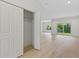 Bright, airy living room with wood floors, closet and large sliding doors that bring the outdoors in at 156 N Cory Dr, Edgewater, FL 32141