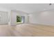 Open-concept living area with wood floors, recessed lighting, and sliding glass doors to enjoy outdoor views at 156 N Cory Dr, Edgewater, FL 32141