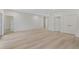 Spacious living room with wood floors, white walls, and ample natural light from surrounding windows at 156 N Cory Dr, Edgewater, FL 32141