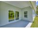 Relaxing covered patio with tile flooring and sliding glass doors to the backyard at 156 N Cory Dr, Edgewater, FL 32141