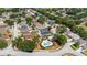 Aerial view of homes in a community, showcasing a swimming pool and manicured landscaping at 15733 Green Point Ct, Clermont, FL 34714