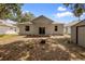 Home exterior with covered porch, large yard, and storage shed at 15733 Green Point Ct, Clermont, FL 34714