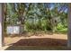 Spacious backyard with a storage shed and mature trees at 15733 Green Point Ct, Clermont, FL 34714
