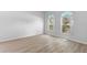Light-filled bedroom featuring wood-look flooring and arched windows with bright, neutral walls at 15733 Green Point Ct, Clermont, FL 34714