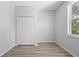 Bright bedroom with hardwood floors, a window, and a double door closet at 15733 Green Point Ct, Clermont, FL 34714