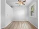 Neutral bedroom with plenty of natural light, ceiling fan, and wood-look vinyl floors at 15733 Green Point Ct, Clermont, FL 34714