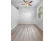 Well-lit bedroom with wood-look vinyl floors and large window bringing the outdoors in at 15733 Green Point Ct, Clermont, FL 34714