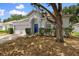 Exterior shot of a home featuring a two-car garage, blue front door, and a landscaped front yard at 15733 Green Point Ct, Clermont, FL 34714