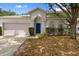 Charming single-Gathering home with a well-maintained lawn and mature tree shading the front at 15733 Green Point Ct, Clermont, FL 34714