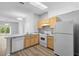 Cozy kitchen featuring matching white appliances, laminate countertops, and warm wood cabinets at 15733 Green Point Ct, Clermont, FL 34714