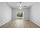 Spacious living room with a ceiling fan and a sliding door leading to a garden at 15733 Green Point Ct, Clermont, FL 34714