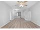 Expansive living room featuring a ceiling fan and an adjacent kitchen area at 15733 Green Point Ct, Clermont, FL 34714