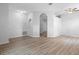 Bright living room featuring an open floor plan, archways, and modern wood-look flooring at 15733 Green Point Ct, Clermont, FL 34714