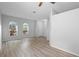 Bright living area with arched windows, wood-look flooring, and an open layout at 15733 Green Point Ct, Clermont, FL 34714