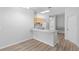 Inviting living area showcasing a kitchen featuring a peninsula and wood-look flooring at 15733 Green Point Ct, Clermont, FL 34714