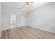 Bedroom featuring wood flooring, neutral walls, ceiling fan, closet, and ensuite bathroom at 15733 Green Point Ct, Clermont, FL 34714