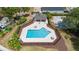 Aerial view of community pool, fenced, with ample seating at 15733 Green Point Ct, Clermont, FL 34714