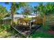 Beautiful backyard retreat with a wooden deck, surrounded by trees and lush vegetation, creating a private and inviting atmosphere at 1613 Crescent Ridge Rd, Daytona Beach, FL 32118